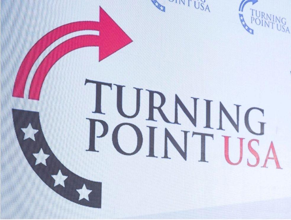 Logo of Turning Point USA with stars and an arrow.